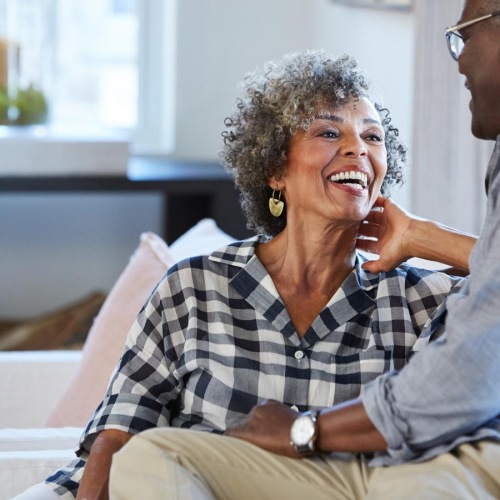 The essence of exceptional living a man and a woman laughing in their living room