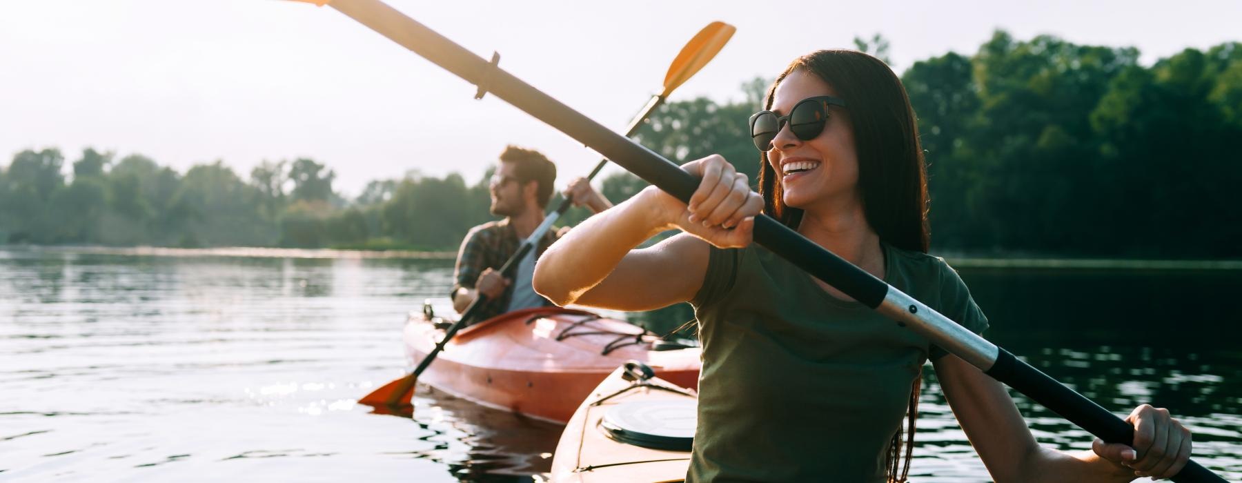 woman and man kayak on a lake