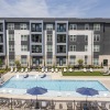Swimming pool with lounge chairs and picnic tables at Gladwen apartments in Wendell, NC