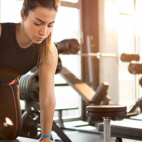 Quick access to state-of-the-art amenities a woman working out in a gym